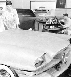 Clay modelers working on both the exterior and interior of a Chrysler 300 proposal.