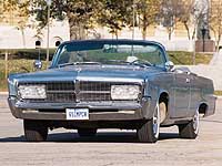 Front 3/4 view of 1965 Imperial convertible in front of Iowa state capitol